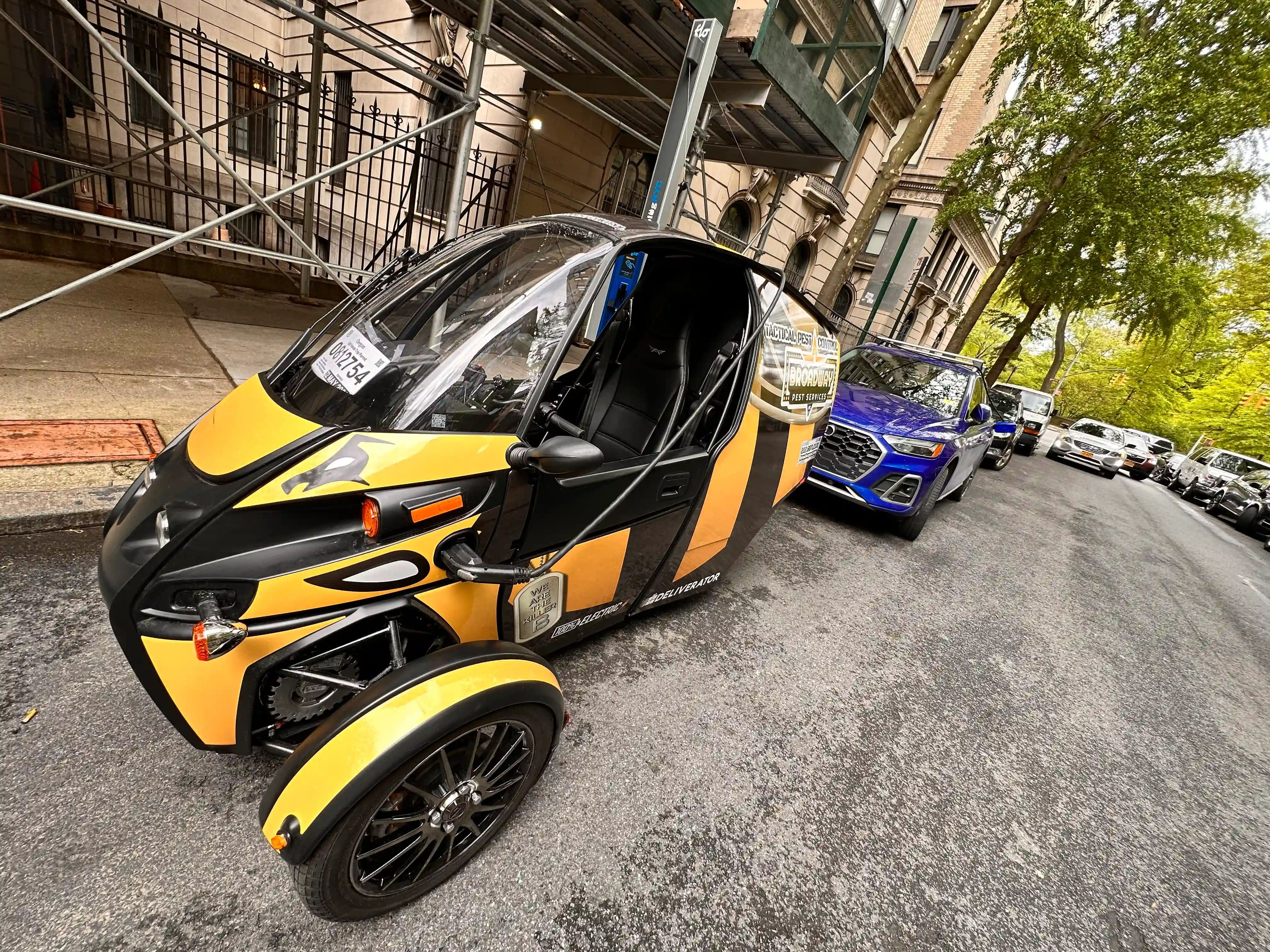 Broadway Pest Services Arcimoto FUV all-electric three-wheeled service vehicle on NYC street