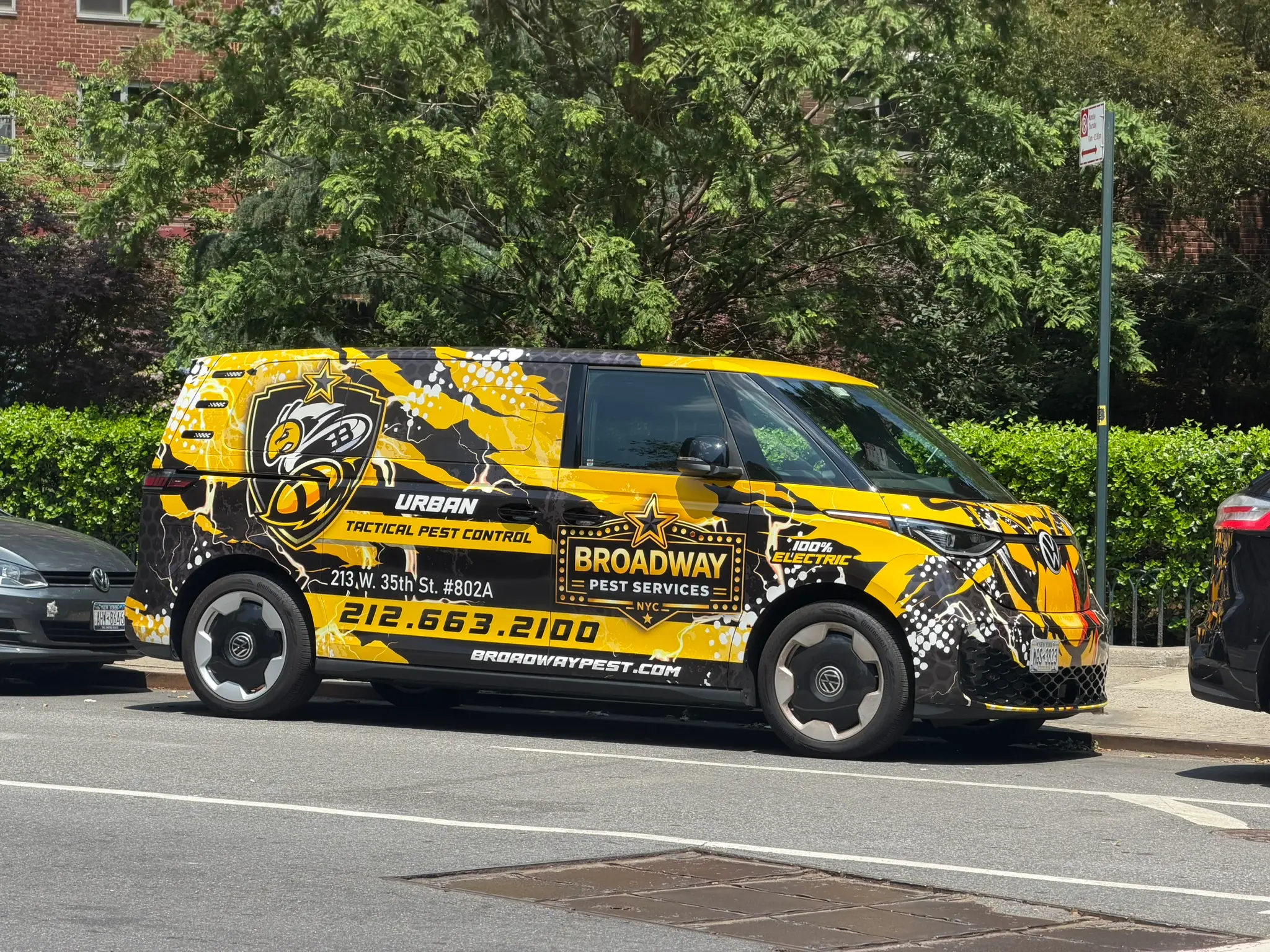 Broadway Pest Services 100% electric Volkswagen ID. Buzz Urban Tactical Pest Control wrap on NYC street